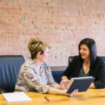 Two Women Speaking About Business.